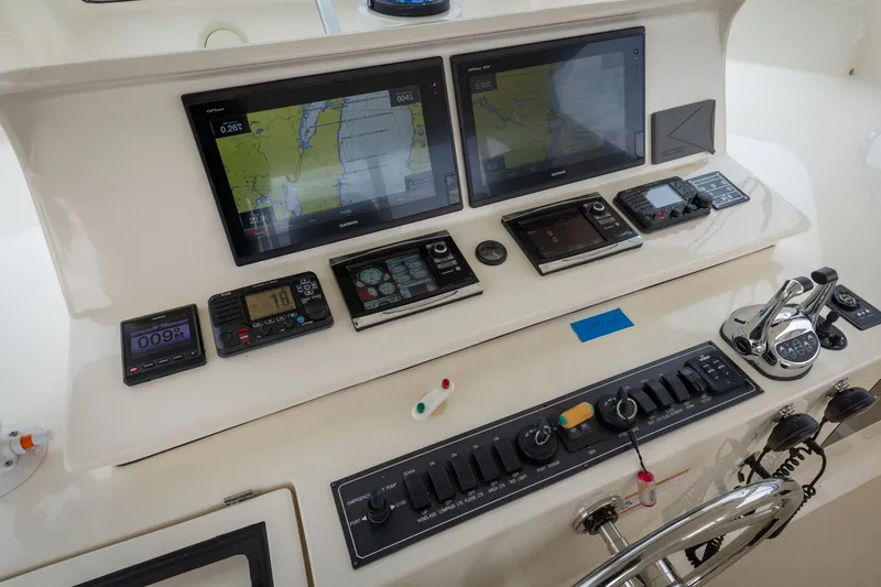 Slide: The Image of Control panel of a 2019 Marlow Explorer 49E yacht with navigation screens and controls. - 83