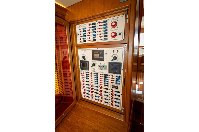 Slide: The Image of Electrical control panel on 2019 Marlow Explorer 49E yacht, featuring switches and displays. - 38