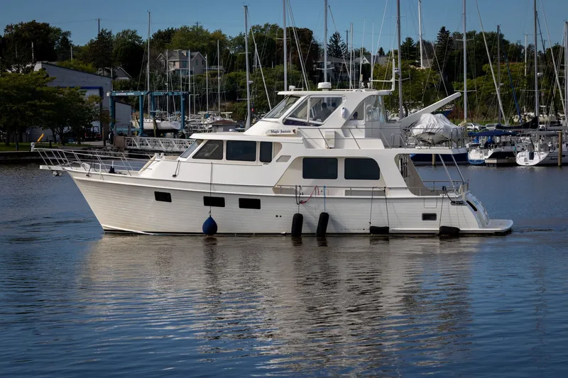Slide: The Image of 2019 Marlow Explorer 49E yacht docked in a marina with sailboats in the background. - 9