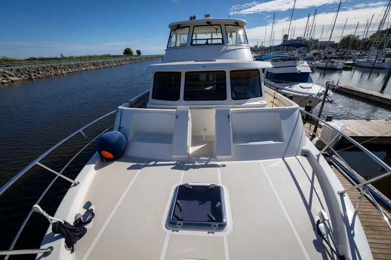 Slide: The Image of 2019 Marlow Explorer 49E yacht docked at a marina under clear blue skies. - 19