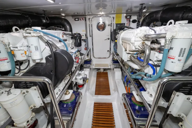 Slide: The Image of Engine room of 2019 Marlow Explorer 49E yacht, showcasing dual engines and mechanical systems. - 73