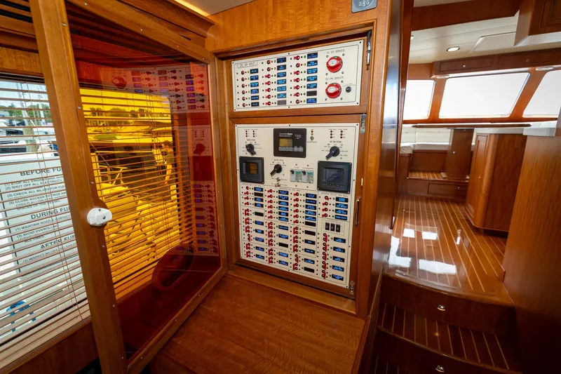 Slide: The Image of 2019 Marlow Explorer 49E yacht interior with control panel and wooden finishes. - 37