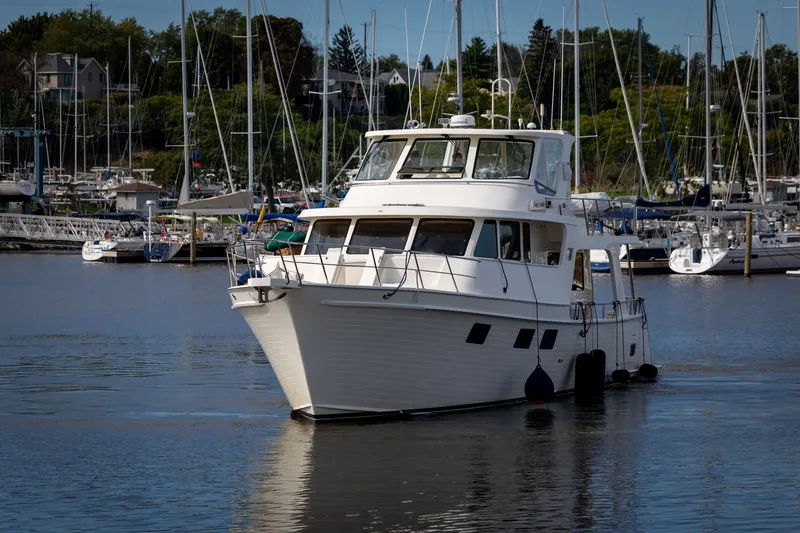 Slide: The Image of 2019 Marlow Explorer 49E yacht docked in a marina with sailboats in the background. - 10