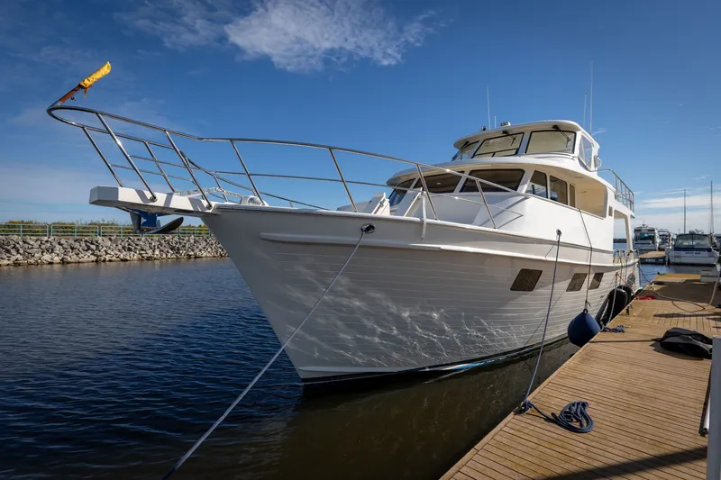 Slide: The Image of 2019 Marlow Explorer 49E yacht docked at marina under clear blue sky. - 12