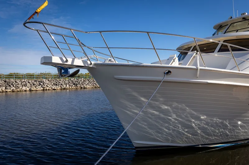 Slide: The Image of 2019 Marlow Explorer 49E yacht docked on calm water under clear blue sky. - 13