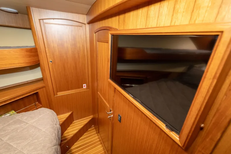 Slide: The Image of Interior of 2019 Marlow Explorer 49E yacht with wood paneling and a mounted TV. - 65
