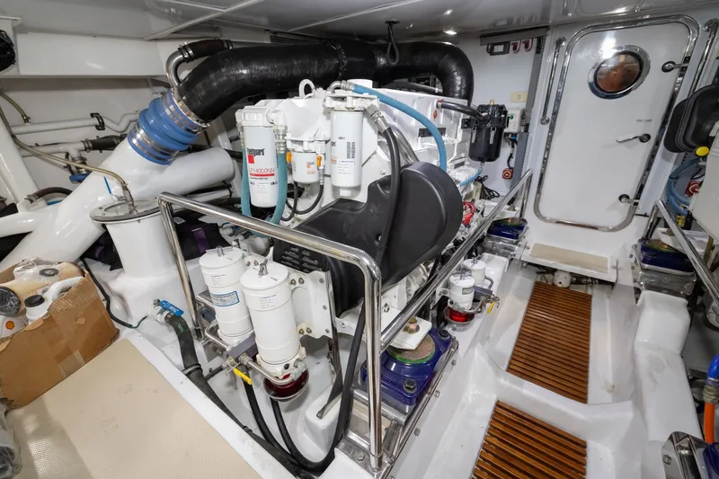 Slide: The Image of Engine room of 2019 Marlow Explorer 49E yacht, showcasing mechanical components and systems. - 75