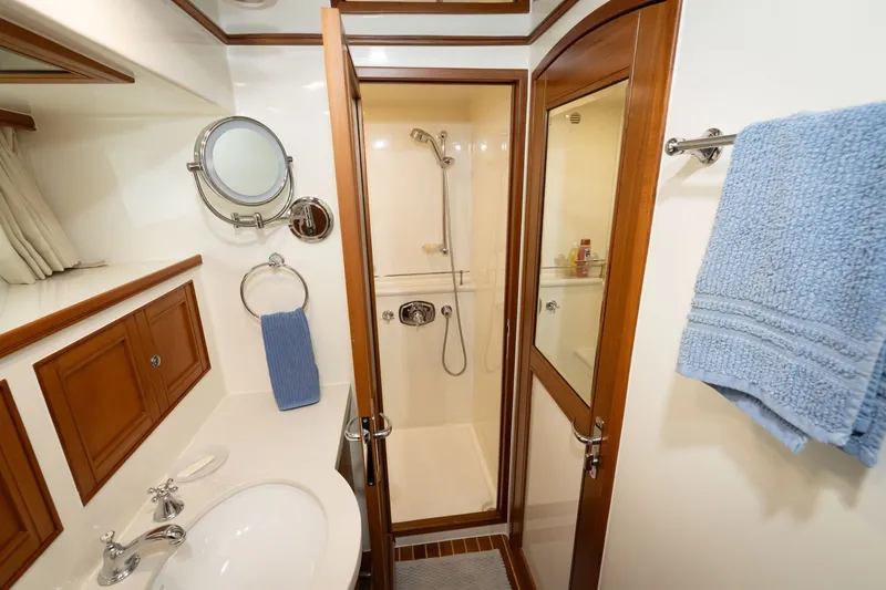 Slide: The Image of Luxurious bathroom in 2019 Marlow Explorer 49E yacht with shower and elegant wood accents. - 60