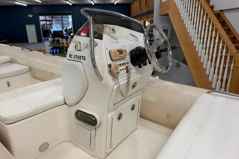 Slide: The Image of 2004 Nautica RIB 15 Widebody boat interior with steering console and seating. - 24