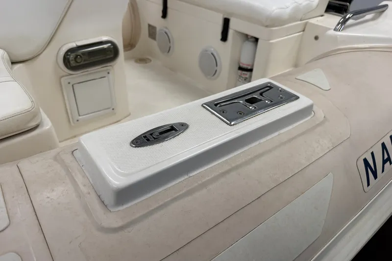 Slide: The Image of 2004 Nautica RIB 15 Widebody boat interior with seating and storage compartments. - 23