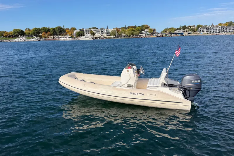 Slide: The Image of 2004 Nautica RIB 15 Widebody boat with Yamaha engine on calm water. - 10