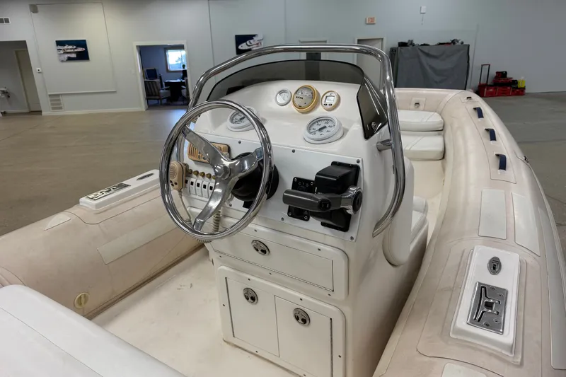 Slide: The Image of 2004 Nautica RIB 15 WIDEBODY boat interior with steering console and gauges. - 18