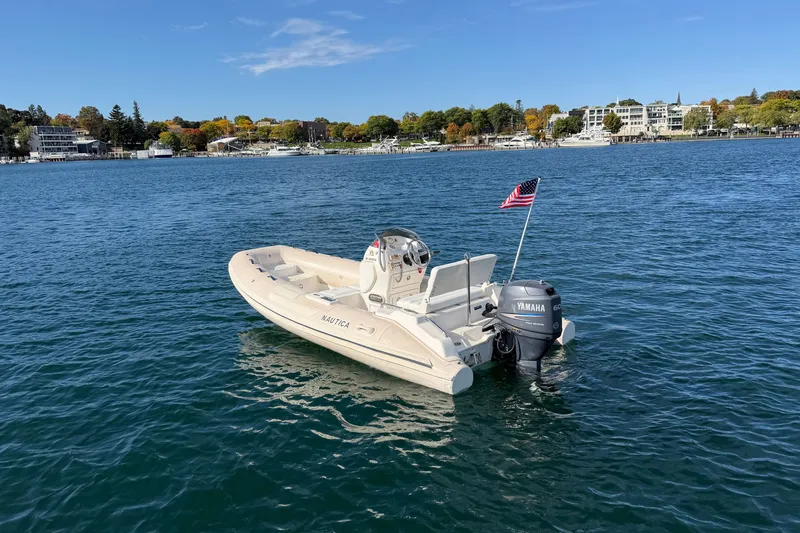 Slide: The Image of 2004 Nautica RIB 15 Widebody boat with Yamaha engine on calm water. - 8