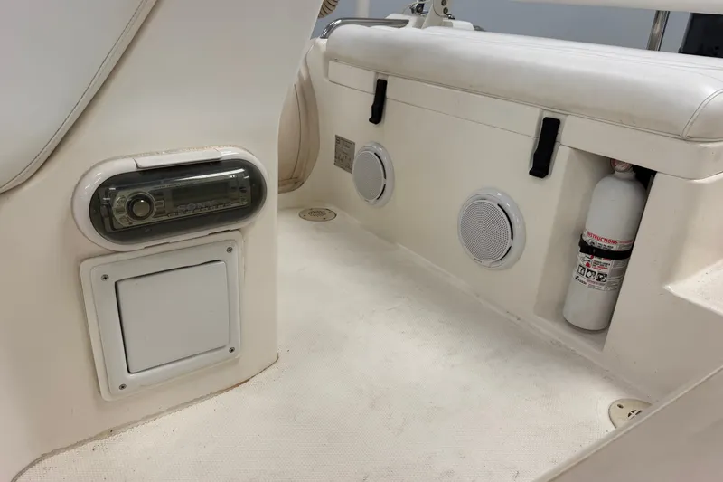 Slide: The Image of 2004 Nautica RIB 15 Widebody interior with stereo, speakers, and fire extinguisher. - 22