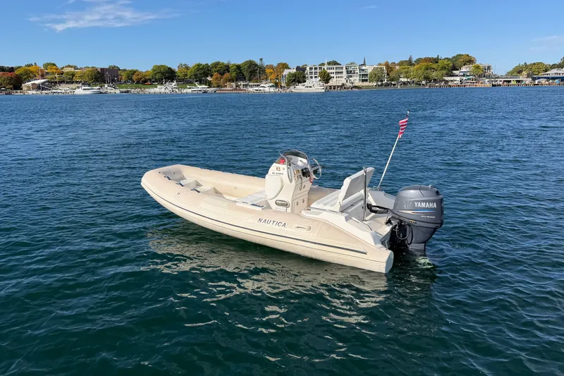 Slide: The Image of 2004 Nautica RIB 15 Widebody boat with Yamaha engine on calm water. - 9