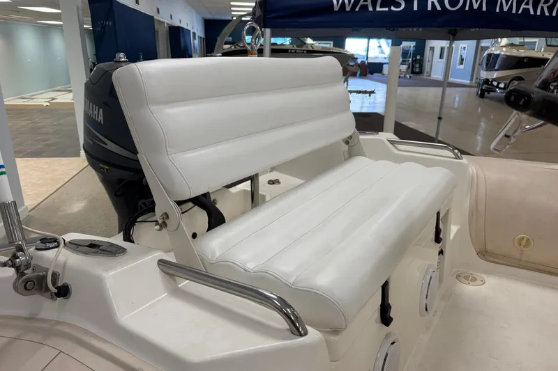 Slide: The Image of 2004 Nautica RIB 15 Widebody boat interior with white seating and Yamaha engine. - 19