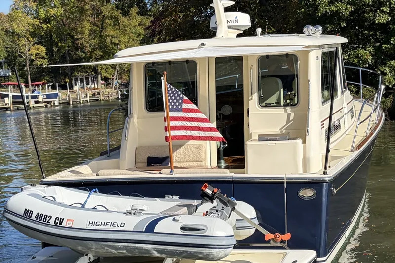 Slide: The Image of 2010 Sabre 40 Sedan yacht with American flag and Highfield dinghy. - 4