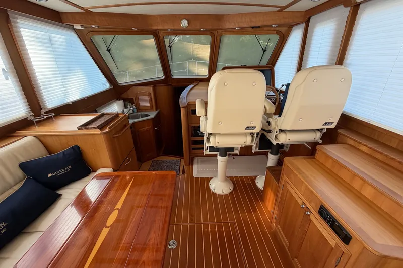Slide: The Image of Interior of 2010 Sabre 40 Sedan yacht with wooden finishes and helm seating. - 14