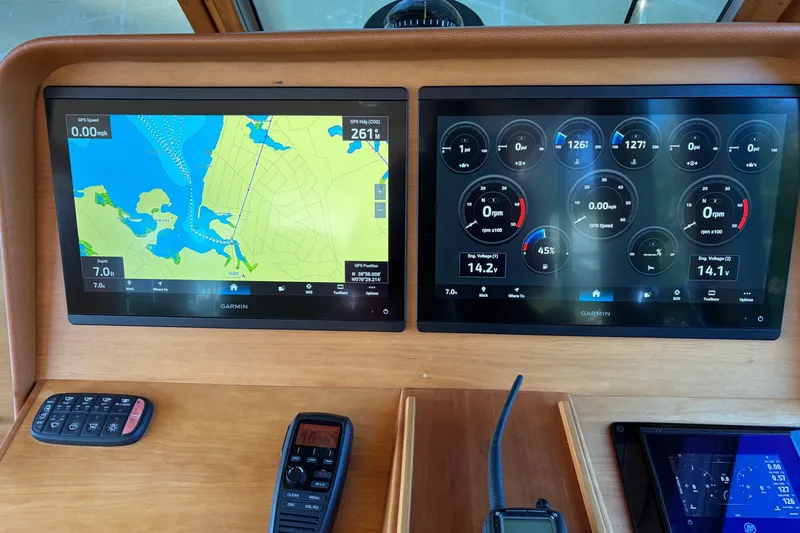 Slide: The Image of Boat dashboard with dual Garmin displays showing navigation and engine data on a 2010 Sabre 40 Sedan. - 10