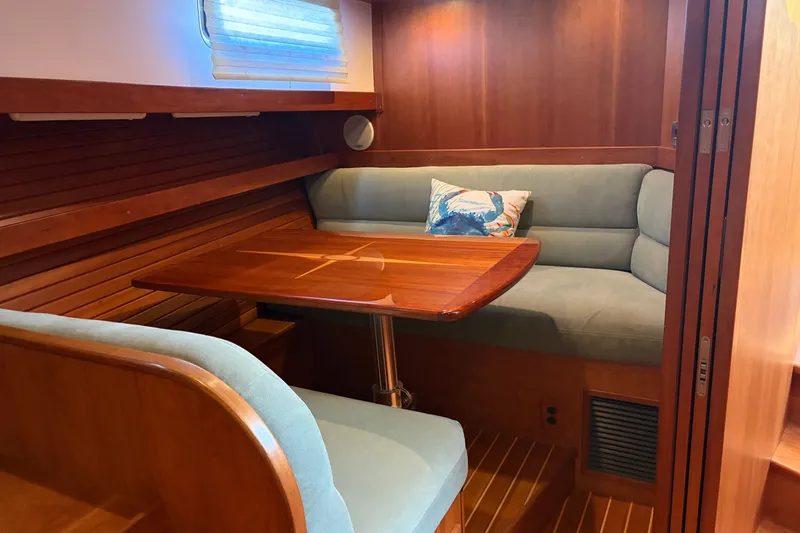 Slide: The Image of Cozy interior of 2010 Sabre 40 Sedan with wooden table and cushioned seating. - 16