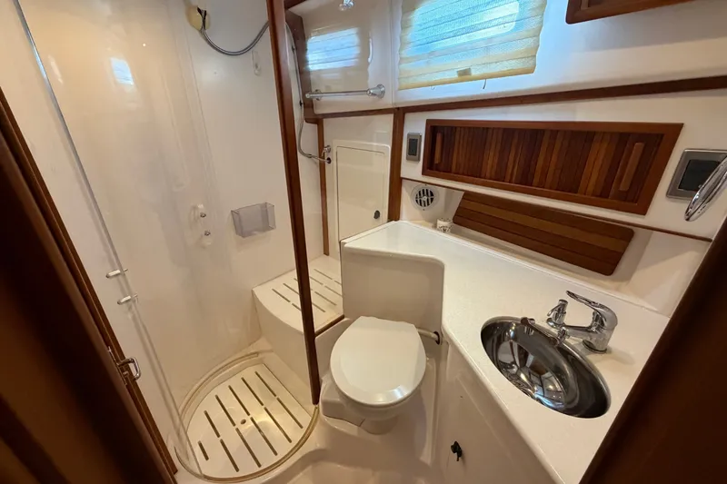 Slide: The Image of Luxurious bathroom in 2010 Sabre 40 Sedan yacht with shower, sink, and toilet. - 18