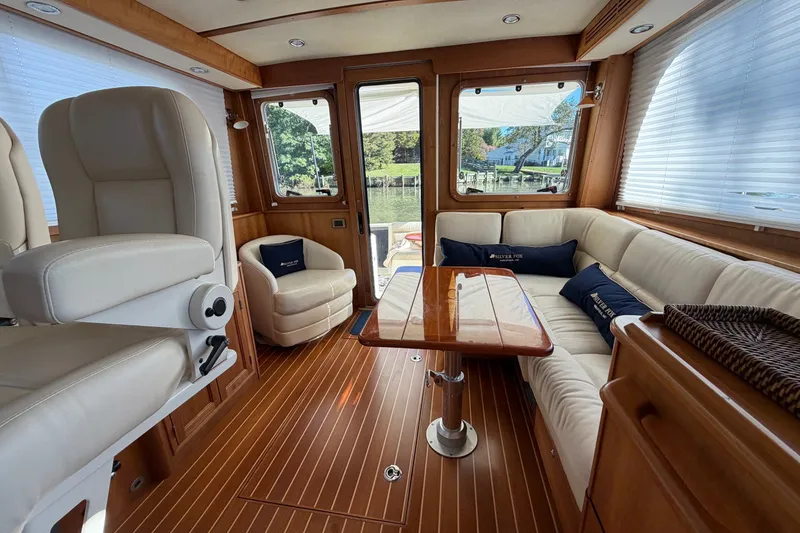 Slide: The Image of Luxurious interior of 2010 Sabre 40 Sedan yacht with plush seating and wooden accents. - 13