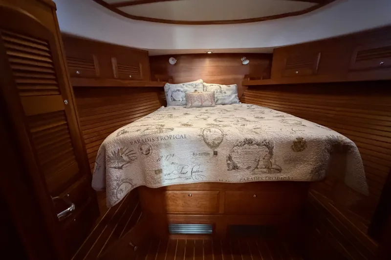 Slide: The Image of Luxurious cabin interior of 2010 Sabre 40 Sedan with cozy bedding and wooden finish. - 20