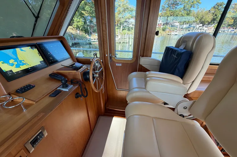 Slide: The Image of Interior of 2010 Sabre 40 Sedan yacht with navigation screens and leather seating. - 12