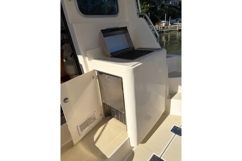 Slide: The Image of 2010 Sabre 40 Sedan yacht with open storage compartment and grill on deck. - 7