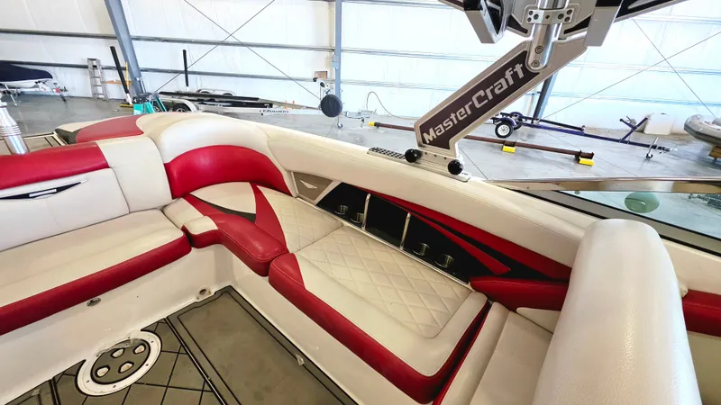 Slide: The Image of Interior of a 2010 MasterCraft X-55 with red and white seating. - 1