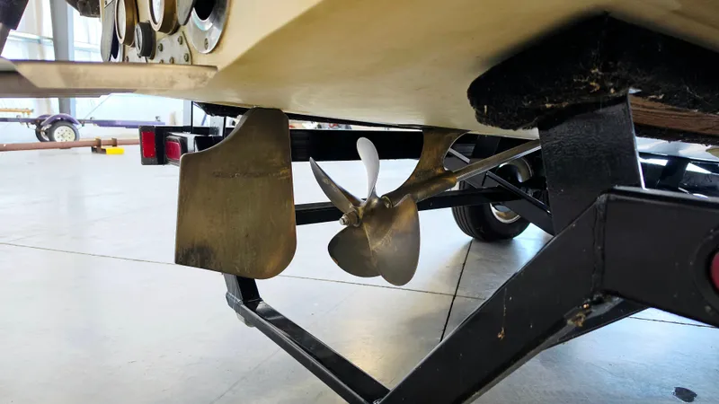 Slide: The Image of Close-up of a boat propeller and rudder on a trailer in a garage. - 11