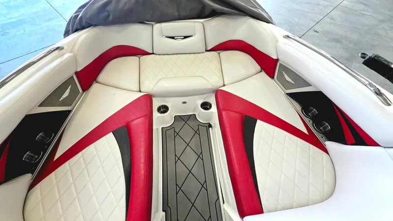 Slide: The Image of The image shows the bow area of a 2010 MasterCraft X-55 boat with red and white upholstery. - 6
