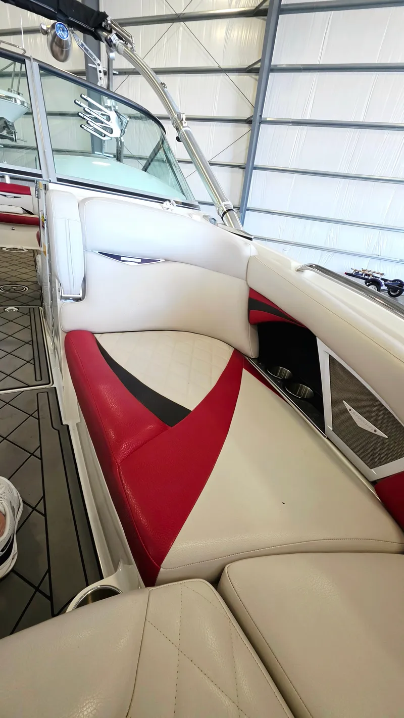 Slide: The Image of The image shows the interior of a 2010 MasterCraft X-55 boat with red and white seating. - 7