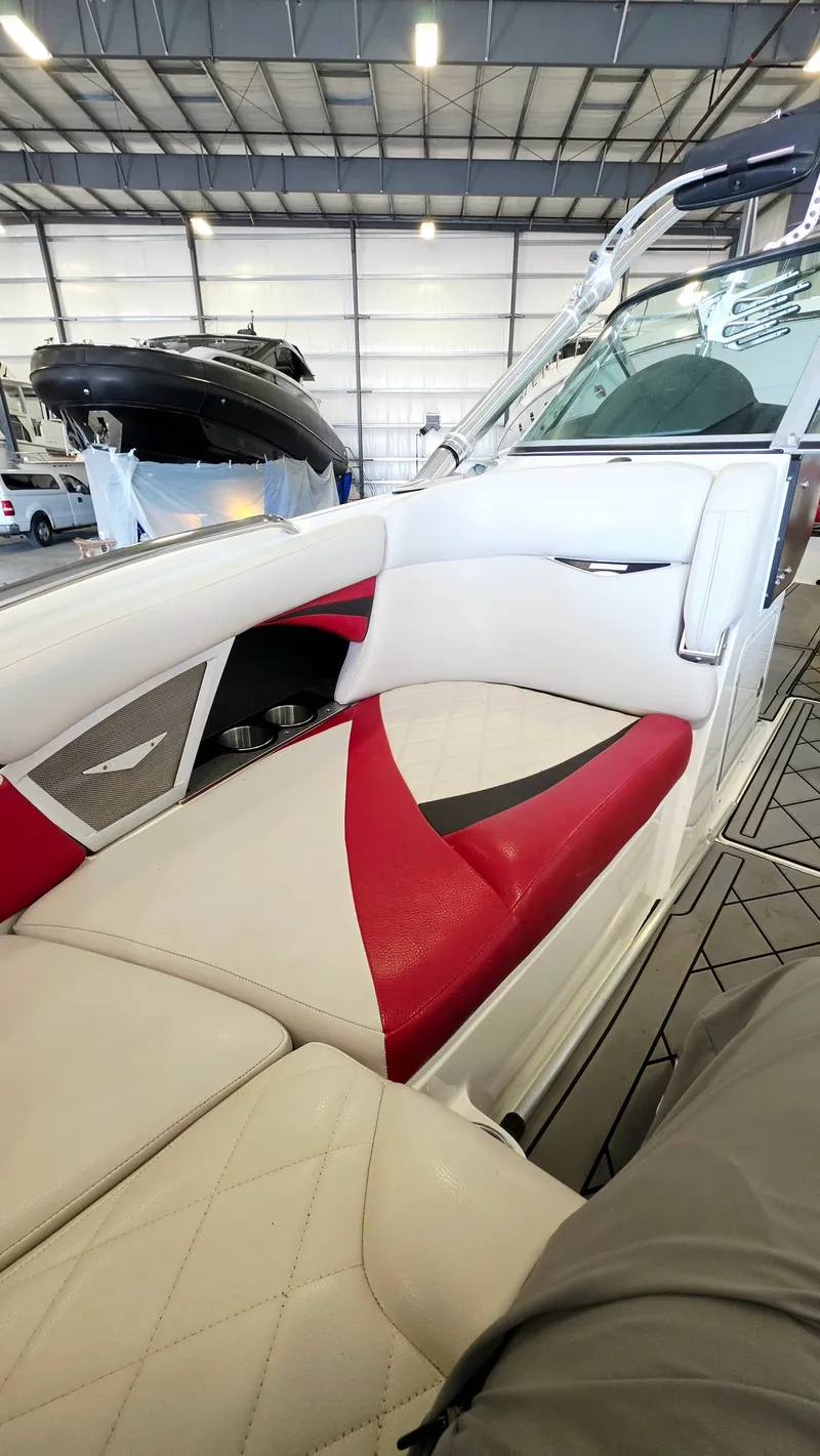 Slide: The Image of The image shows the interior of a 2010 MasterCraft X-55 boat with red and white seating. - 8