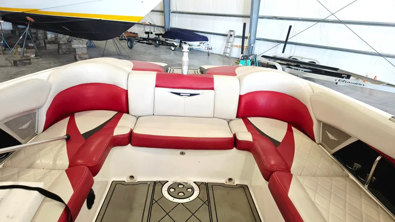 The Image of The image shows the interior of a 2010 MasterCraft X-55 boat with red and white seating. - 0