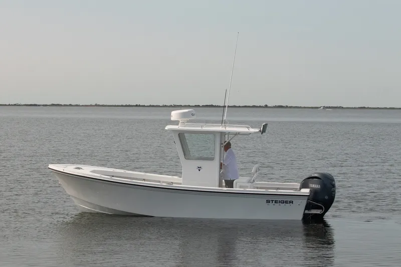 Slide: The Image of 2027 Steiger Craft 23 Chatham boat on calm water, side view. - 2