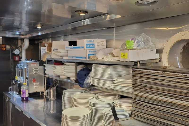Slide: The Image of Kitchen area on a 1978 Blount Passenger vessel with stacked dishes and supplies. - 20