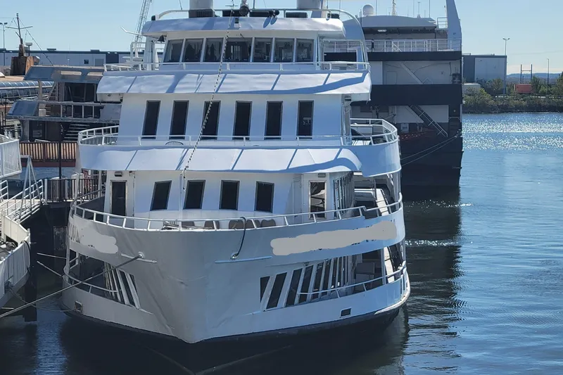 Slide: The Image of A 1978 Blount Passenger ship docked at a marina under clear skies. - 31