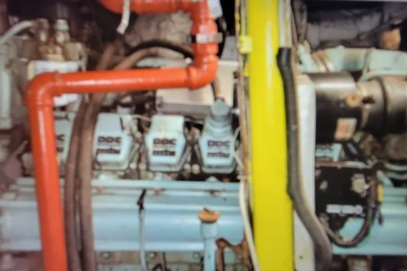 Slide: The Image of Engine compartment of a 1978 Blount Passenger vehicle, featuring visible pipes and components. - 28