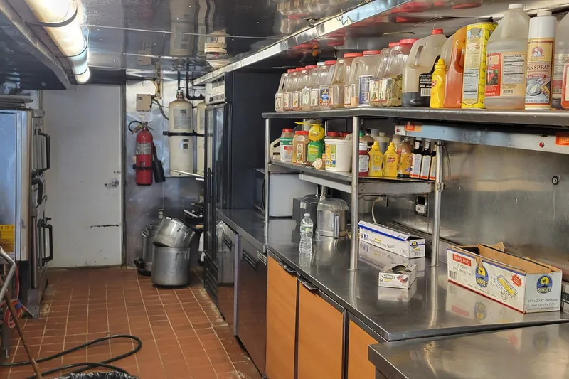 Slide: The Image of 1978 Blount Passenger ship kitchen with stainless steel counters and various condiments. - 19