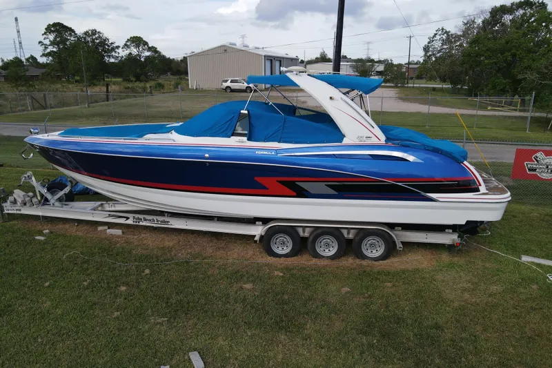 Slide: The Image of 2015 Formula 350 FX Crossover Bowrider on trailer, blue and white design. - 13