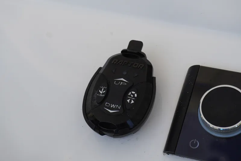 Slide: The Image of Remote control and dial on 2024 Sportsman Masters 267OE Bay Boat console. - 32