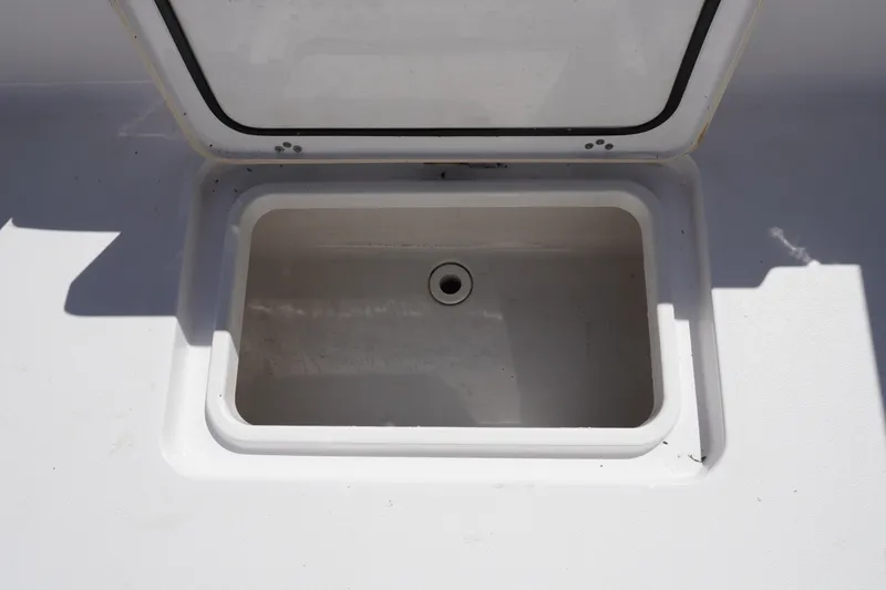 Slide: The Image of 2024 Sportsman Masters 267OE Bay Boat storage compartment with open lid. - 21