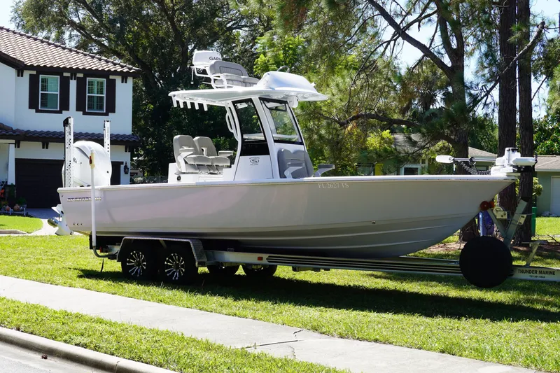 The Image of 2024 Sportsman Masters 267OE Bay Boat on trailer in residential area. - 0