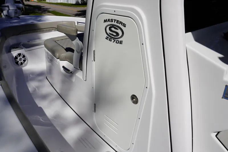 Slide: The Image of 2024 Sportsman Masters 267OE Bay Boat interior with seating and storage compartment. - 53