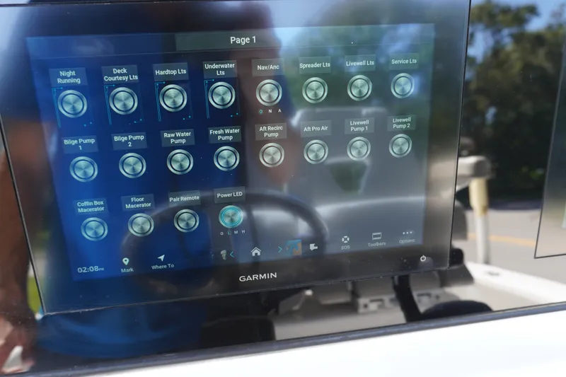 Slide: The Image of Garmin touchscreen display on 2024 Sportsman Masters 267OE Bay Boat, showing various control options. - 33