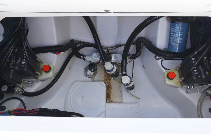 Slide: The Image of 2024 Sportsman Masters 267OE Bay Boat engine compartment with wiring and components. - 23