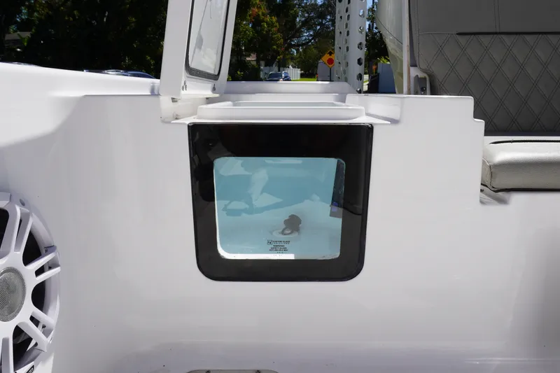 Slide: The Image of 2024 Sportsman Masters 267OE Bay Boat interior with storage compartment and speaker. - 16