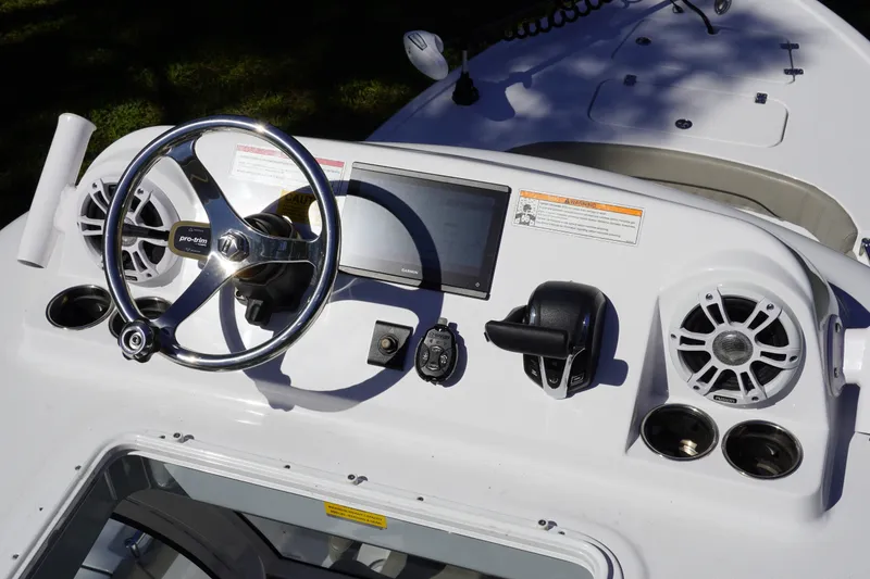 Slide: The Image of 2024 Sportsman Masters 267OE Bay Boat dashboard with steering wheel and controls. - 48