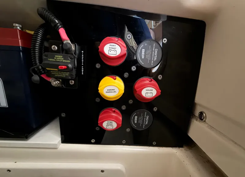 Slide: The Image of Close-up of a boat control panel with various switches and gauges. - 18